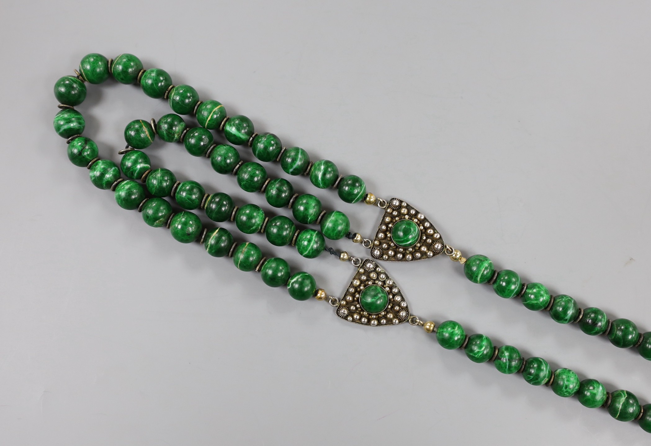 A 20th century Chinese single/double strand malachite bead necklace, with white metal clasp and triangular motifs, stamped 'China Liu Silver', 67cm.